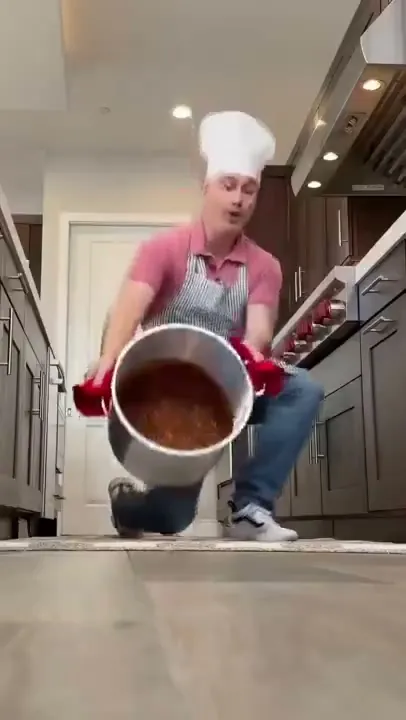 A dad in a chef's hat hauling a giant pot of sauce, in @gettishow's family skit for HelloFresh, which has 380,785 views on Instagram